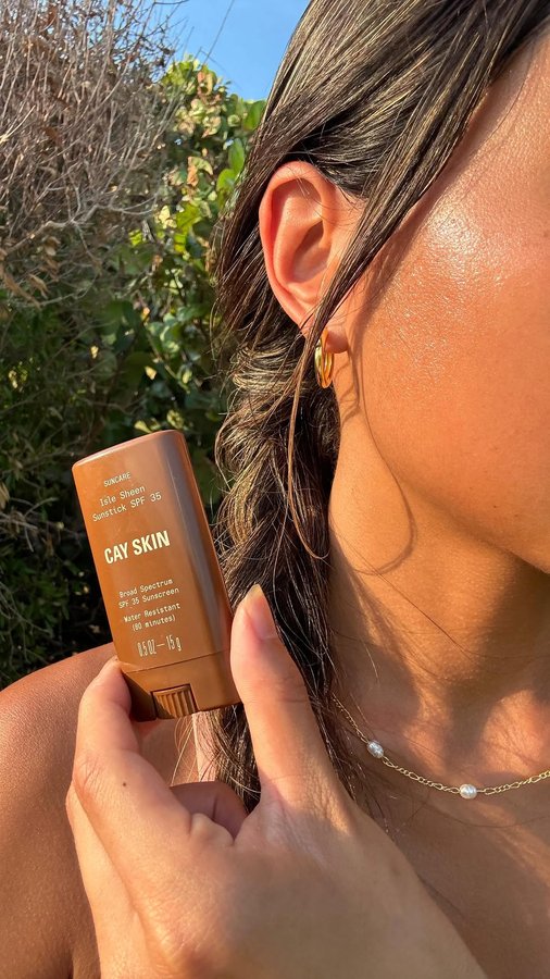 Instagram post by @itscaroxline for Cay Skin. Caption reads: [...] you should be applying sunscreen?? with....