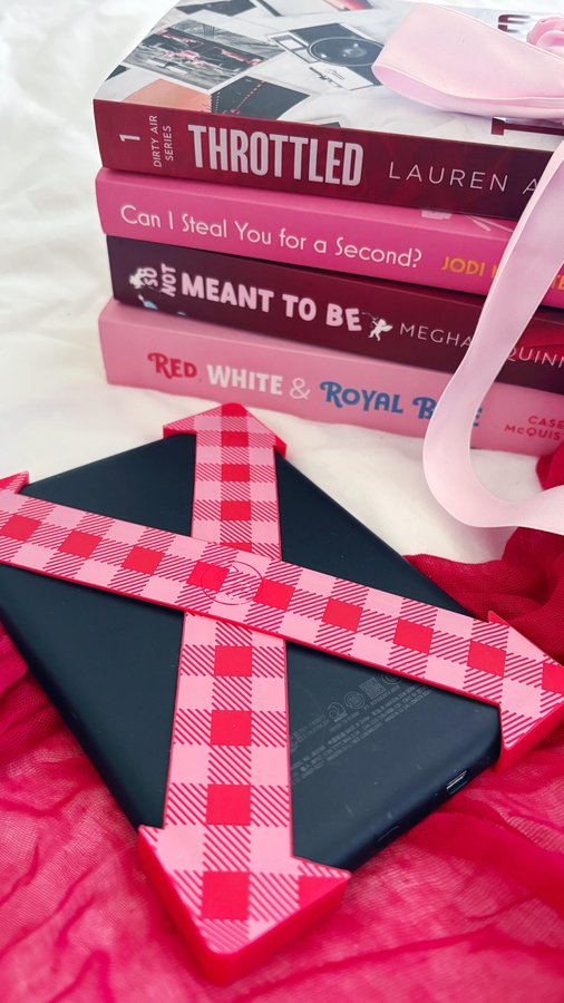 Instagram post by @bookdragonbec for Strapsicle. Caption reads: Strapsicle: for all your one handed reading needs....