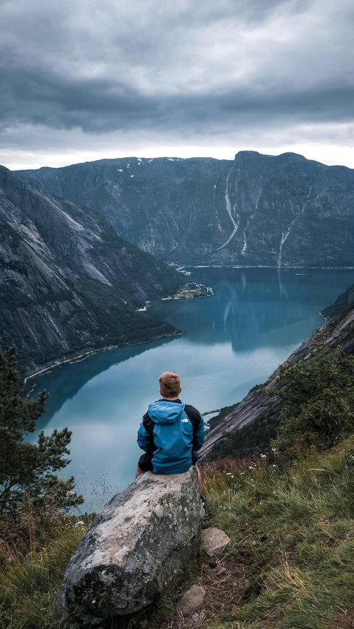 Instagram post by @travel_with_domi for American Tourister. Caption reads: #ad Traveling to Norway with my....