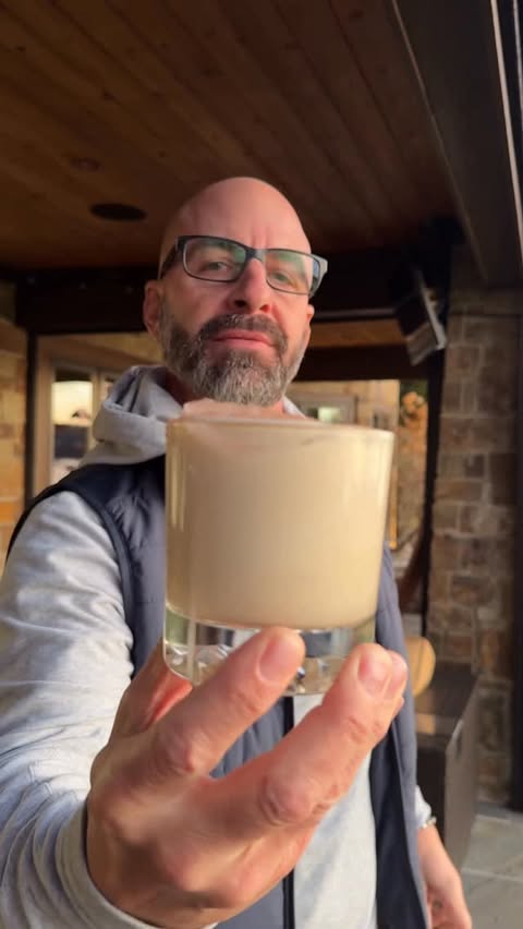 Instagram post by @johnnydrinks_ for OLIPOP. Caption reads: [...] Bulldog Cocktail 🥛 🥤 @drinkolipop....