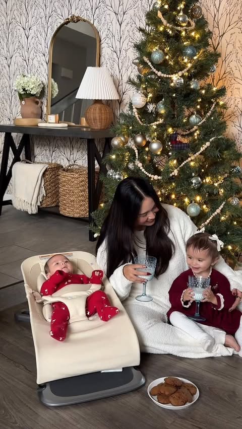 Instagram post by @itsmarisaherr for Ergobaby. Caption reads: This is how traditions begin 🤍 Flour on the....