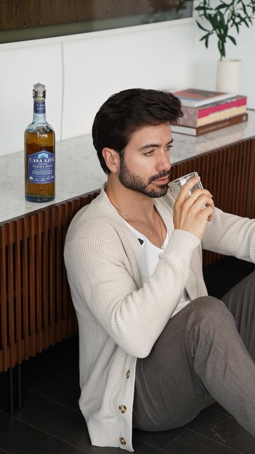 Instagram post by @alexcosta for Casa Azul Spirits. Caption reads: GRWM while I sip on @casaazulspirits añejo for a....