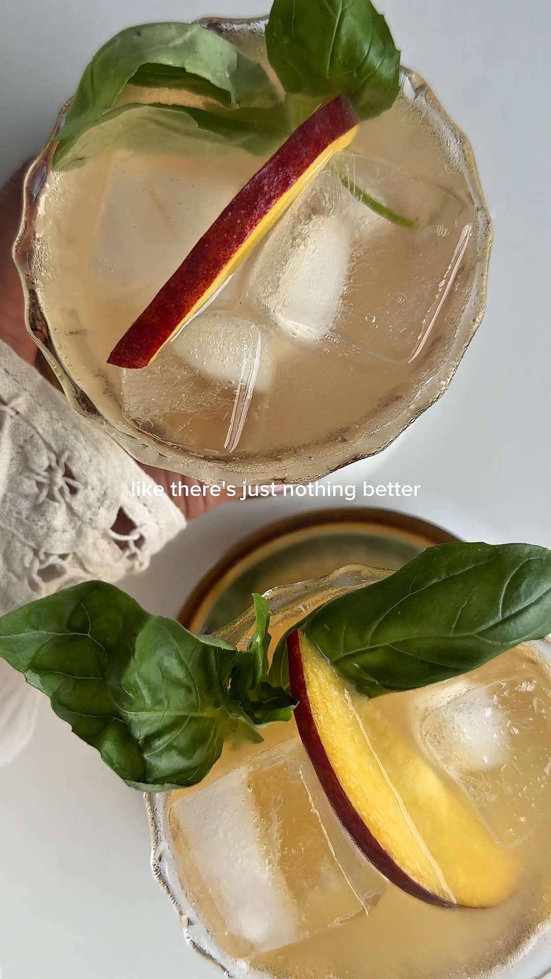 TikTok post by @babytamago for Q Mixers. Caption reads: basil ‘n peach spritz 🍑 the perfect patio bev for....