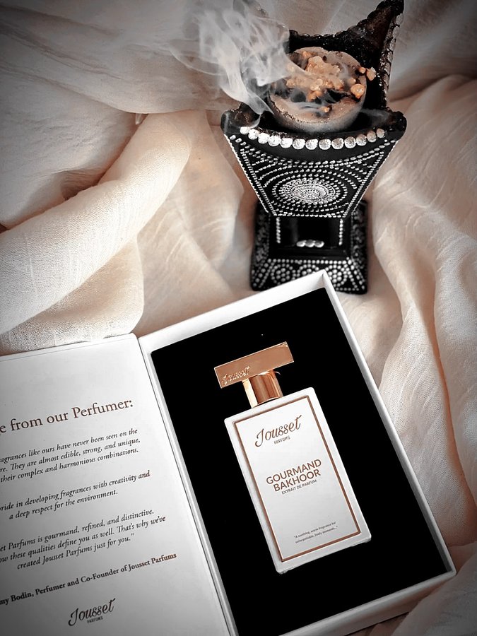 Instagram post by @the.amira.edit for Jousset Parfums. Caption reads: In the warm evening of Al Seef, where the creek....