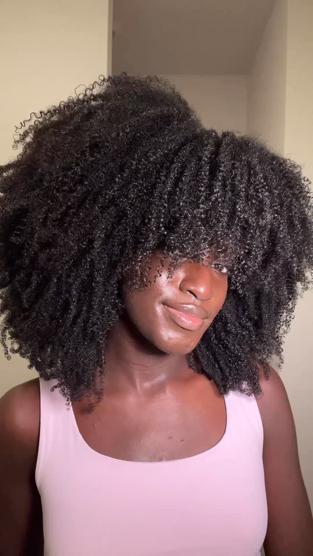 Instagram post by @anima.agyeman for Conair. Caption reads: #ad Living for these curls! The bigger the hair....