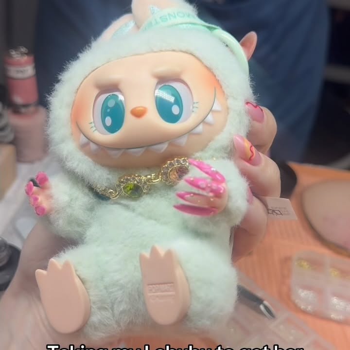 Instagram post by @tiffanyinokc for Pop Mart. Caption reads: Taking my labubu to get her nails done! She got a....
