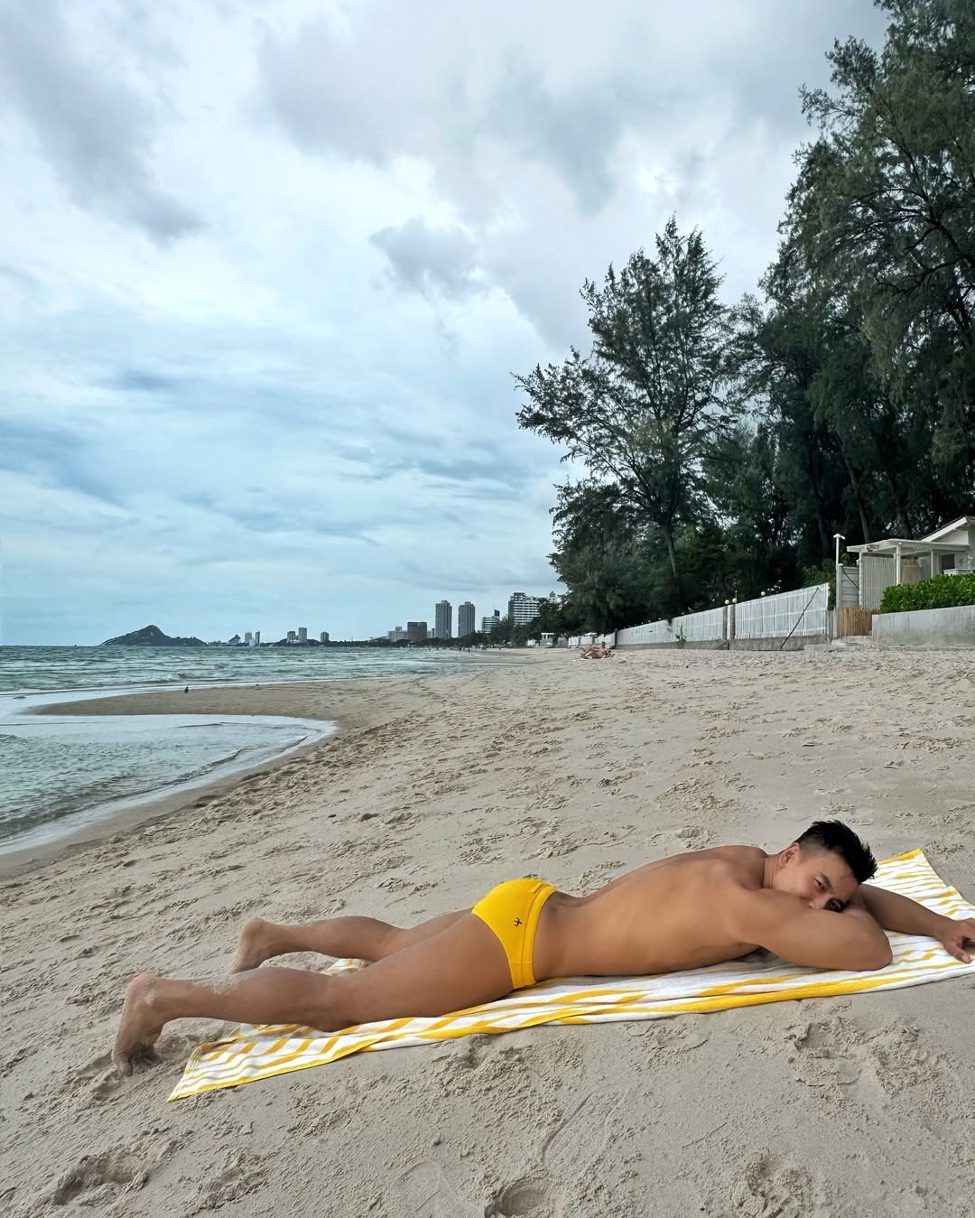 Instagram post by @sklow for The Gay Passport. Caption reads: Relaxing day by the beach 🏖️ 

📍....