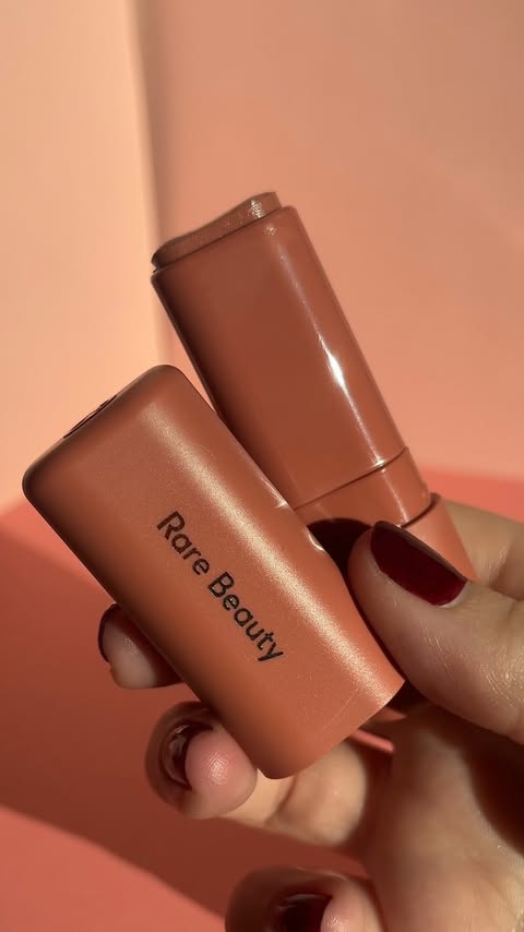 Instagram post by @evergreenandbloom for Skeepers. Caption reads: New @rarebeauty Find Comfort Lip Butter Balm in....