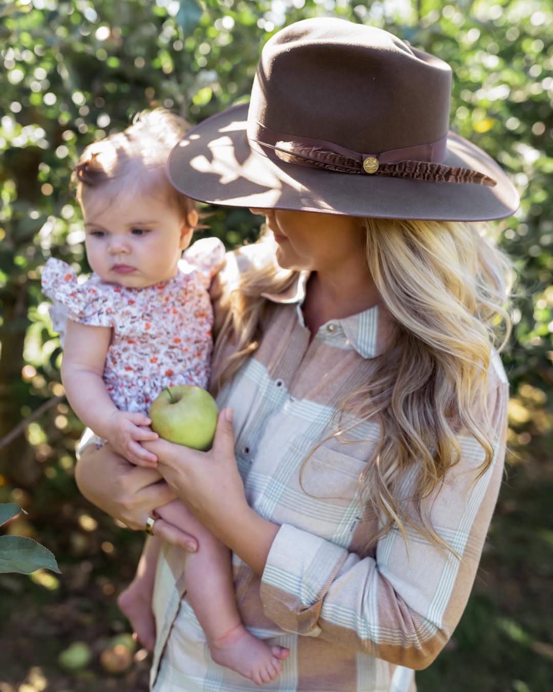Instagram post by @cristincooper for Backcountry. Caption reads: Sharing Isla’s first trip to the apple orchard and....