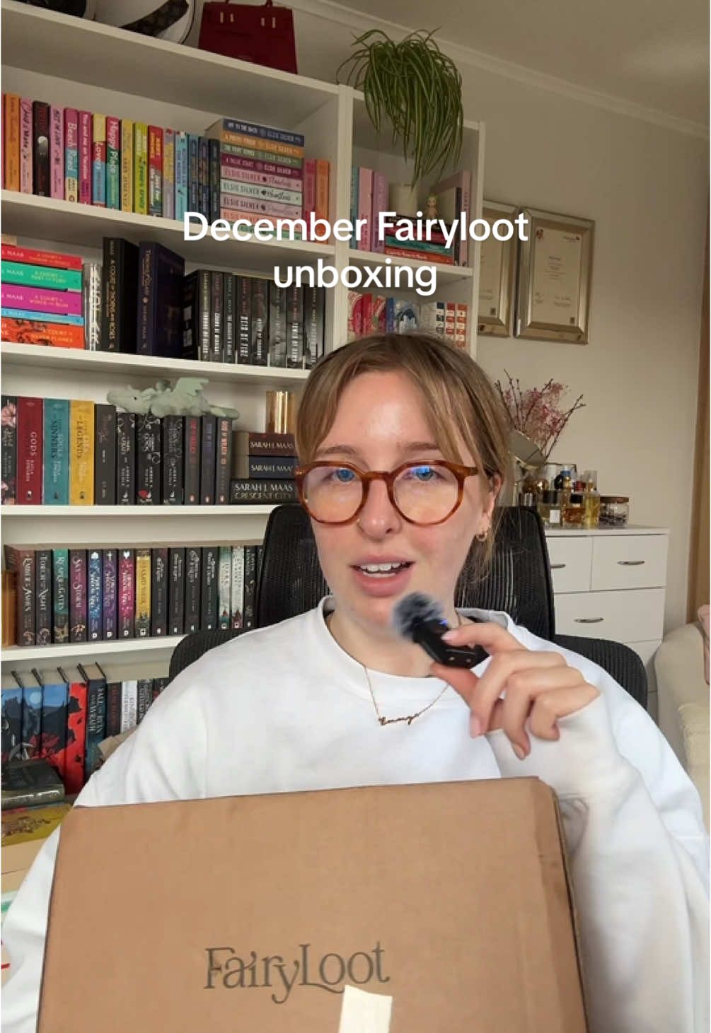 TikTok post by @whatemmyreads for FairyLoot. Caption reads: December @FairyLoot unboxing! ⭐️ Let's open some....