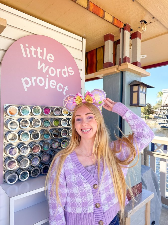 Instagram post by @laurensfloatinglights for Little Words Project. Caption reads: Making friendship bracelets in Disney Springs!....