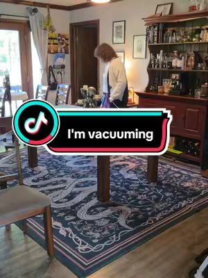 TikTok post by @laurawiththecurls for Lahome. Caption reads: [...] obsessed with my dark and moody rug 🐍....