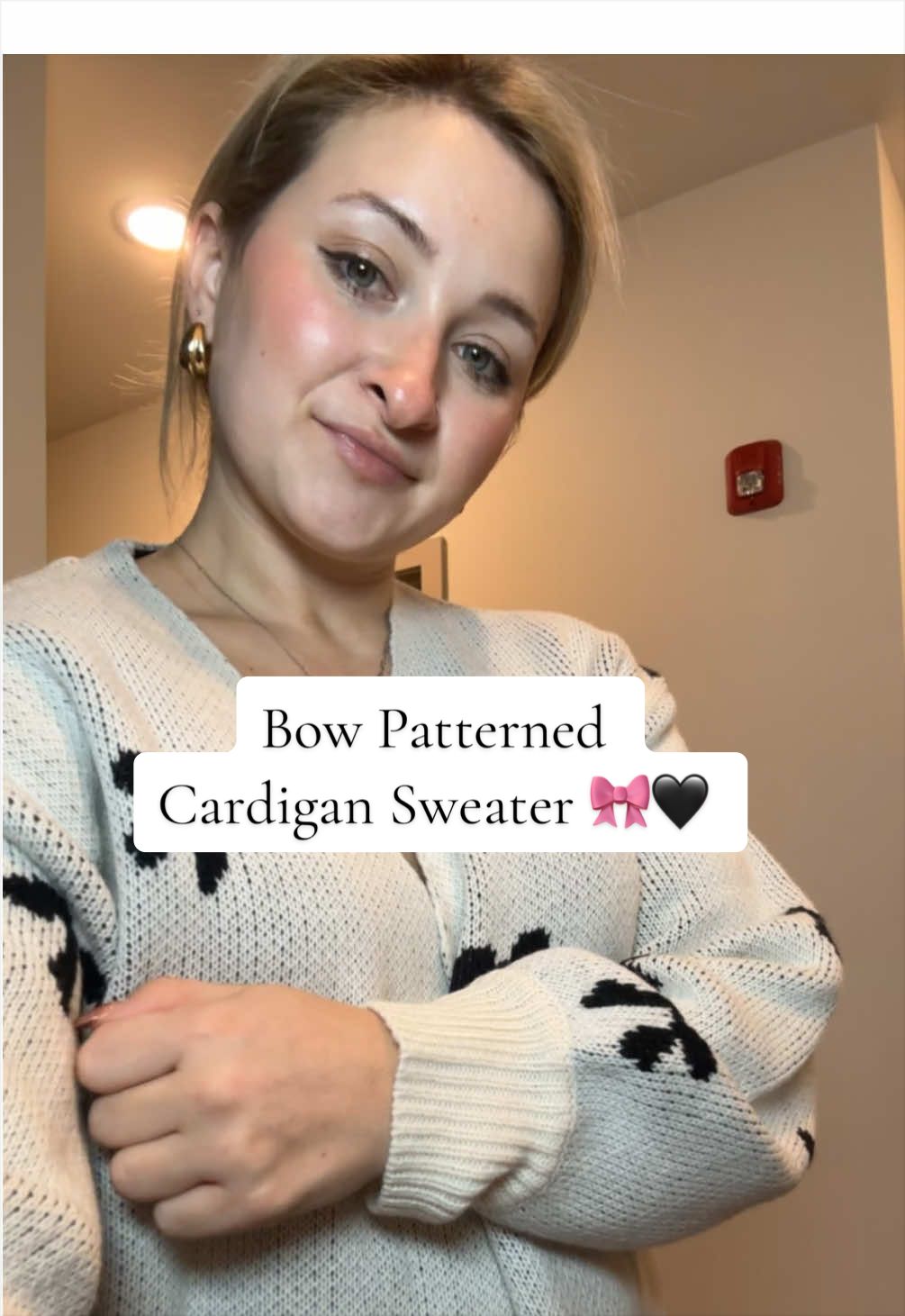 TikTok post by @fitnurse11 for YouAnnn. Caption reads: Bow Patterned Cardigan Sweater 🎀🖤 @YouAnnn....