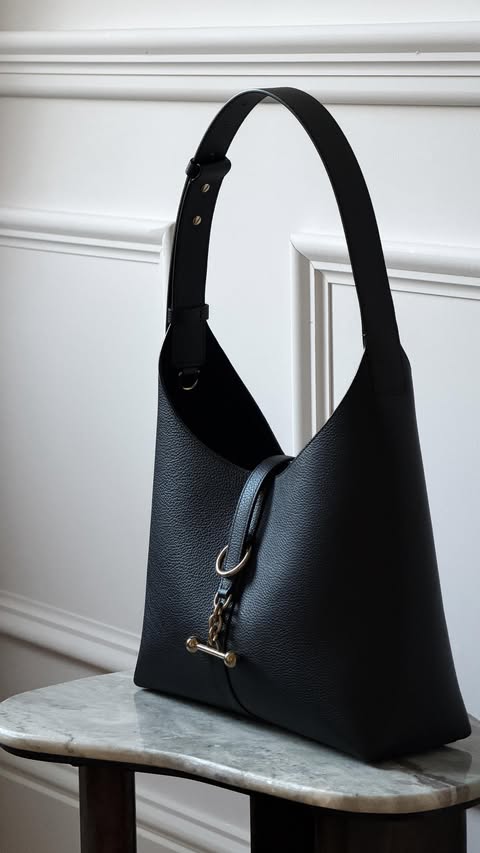 Instagram post by @handbag_holic for Strathberry. Caption reads: [...] moment, it’s the latest bag from....