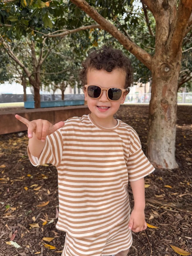 Instagram post by @jesstuyau for Polarised Baby Sunglasses. Caption reads: Curls, sunshine & his favourite shades ☼🕶️ DC |....