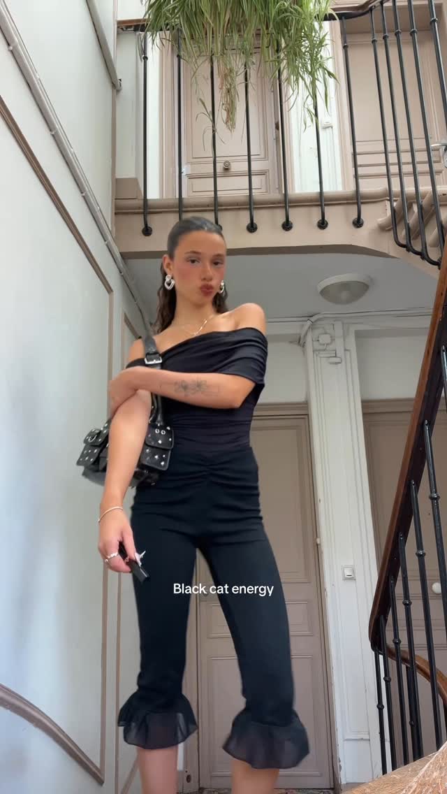 Instagram post by @emmyvmp for The Kooples. Caption reads: 🐈‍⬛.