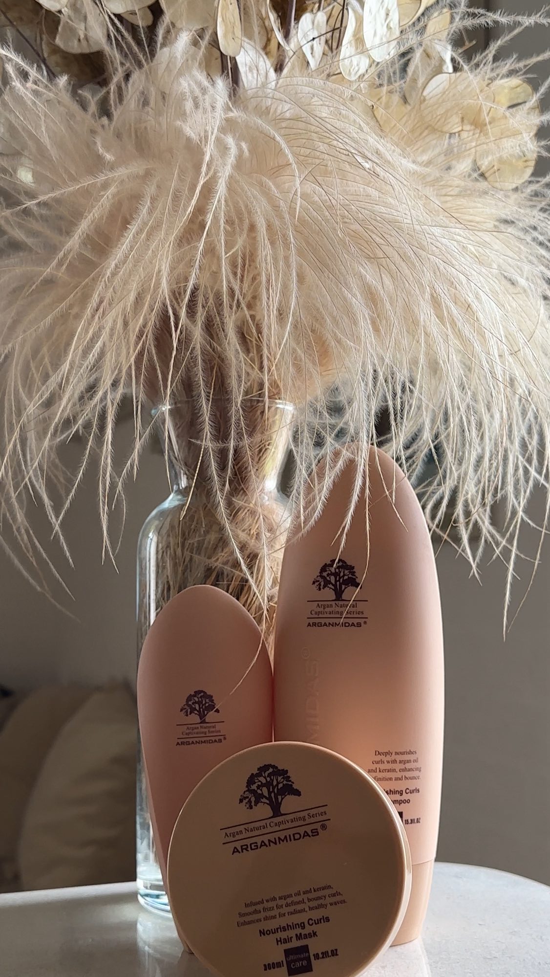 Instagram post by @anita_batonisashvili for Arganmidas. Caption reads: Arganmidas Nourishing Curls Essence makes my curls....