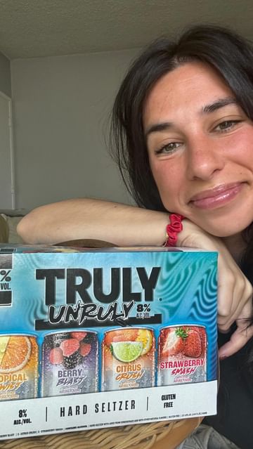 Instagram post by @brookeaverick for Truly Hard Seltzer. Caption reads: #ad #21+ Spoiler alert: I ordered a coloring book,....