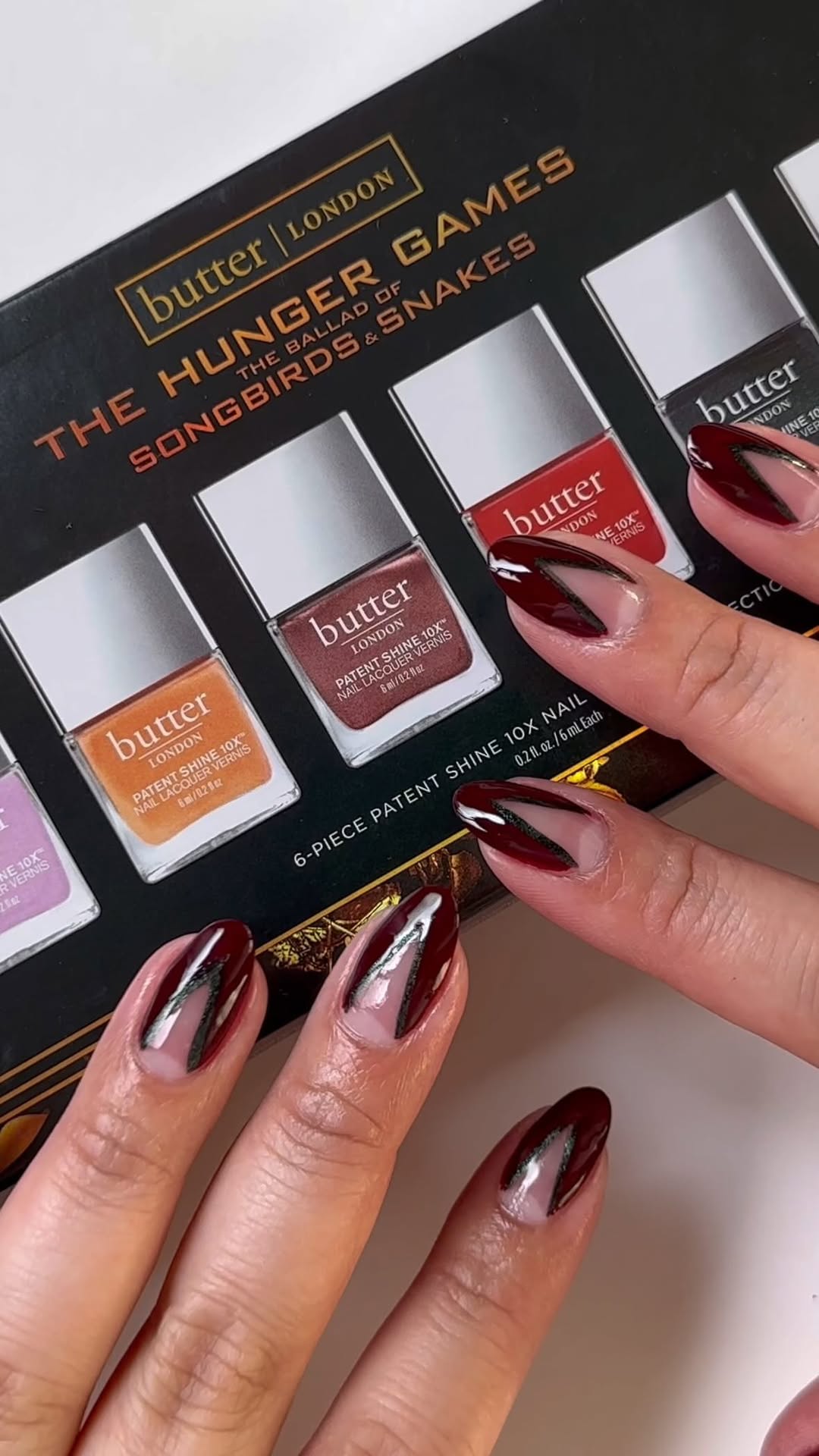 Instagram post by @nailartbysig for butter LONDON. Caption reads: [...] welcome to the Hunger Games! @butterlondon....