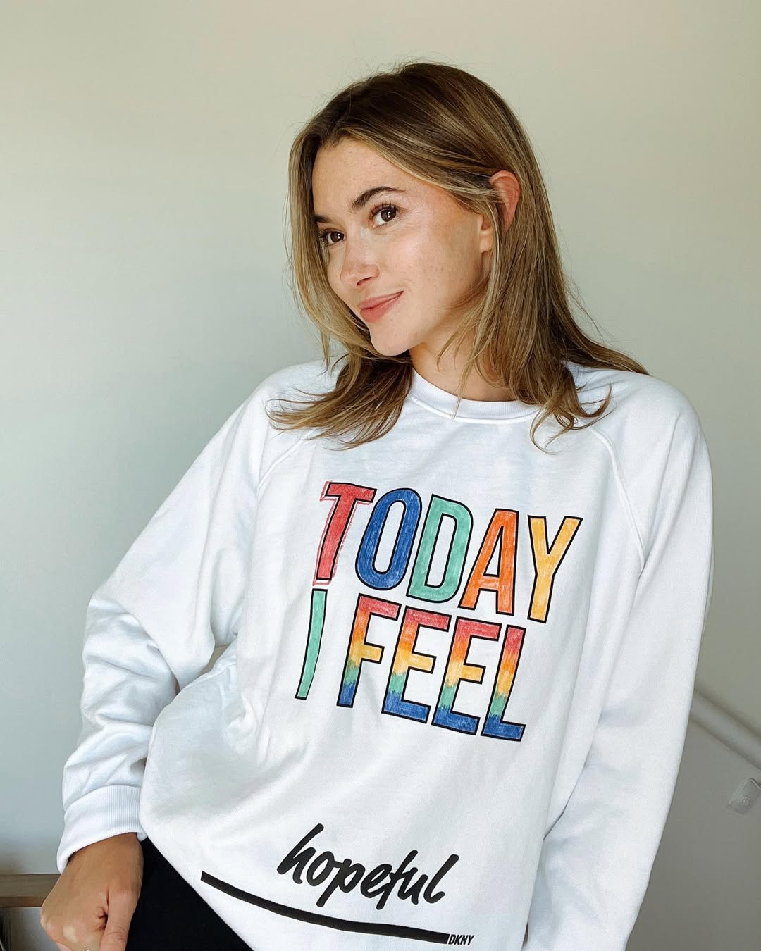 Instagram post by @madeleinecwhite for DKNY. Caption reads: Today I feel hopeful... that my coloring skills....