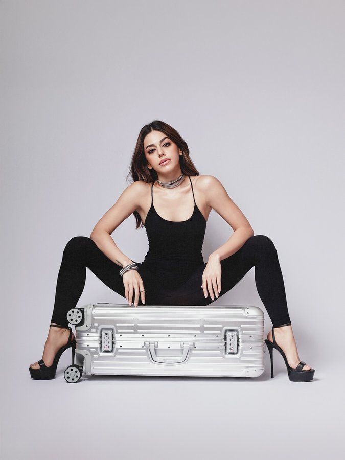 Instagram post by @alayaf for RIMOWA. Caption reads: Just a girl and her baggage (and a guest....