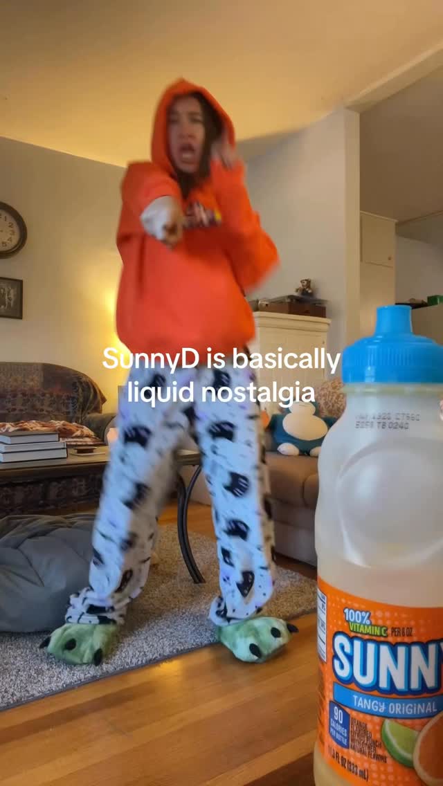 Instagram post by @jillsta12 for SUNNYD. Caption reads: A cold SunnyD with a side of cartoons😮‍💨....