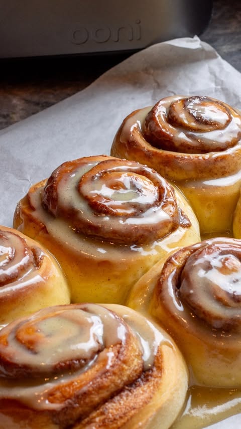 Instagram post by @kitchen_bythesea for Ooni. Caption reads: [...] milk-bread cinnamon rolls made in the....
