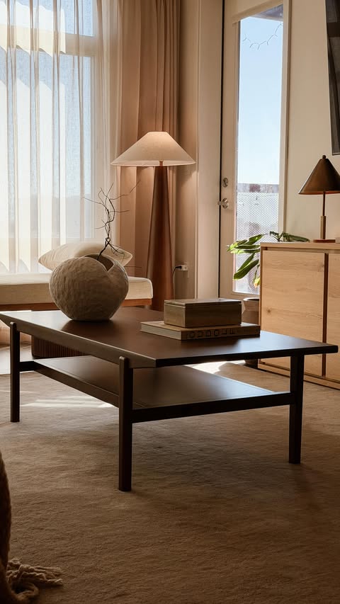 Instagram post by @neutral_homebody for Article. Caption reads: [...] with a dark walnut coffee table from....