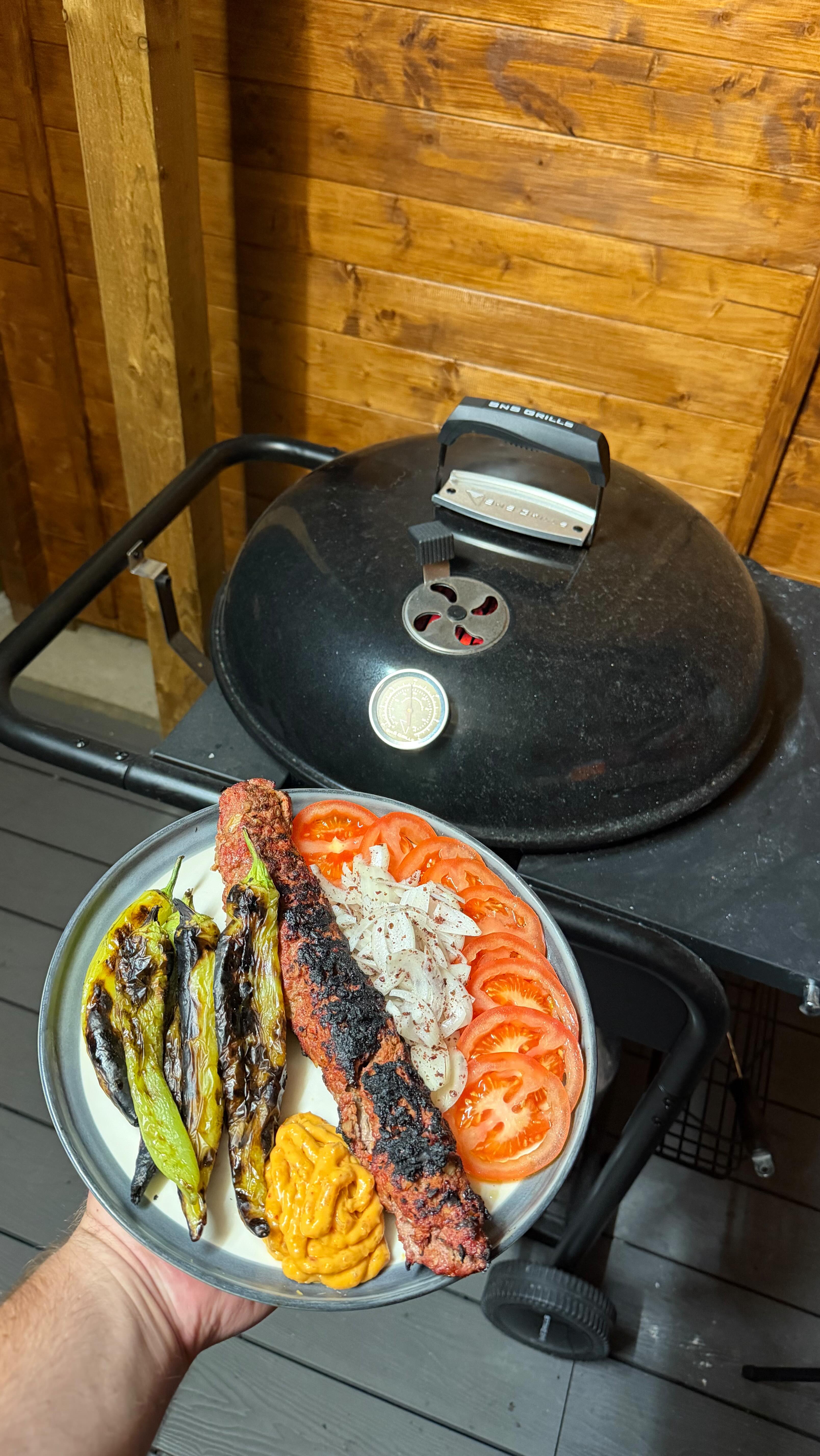 Instagram post by @meatsmith_ for SNS Grills. Caption reads: [...] Adana Kebabs cooked on my @snsgrills....