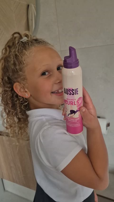 Instagram post by @twin_momma_mullings for Aussie Hair. Caption reads: Frizz Free Friday with @aussiehair mousse 👩🏼‍🦱....