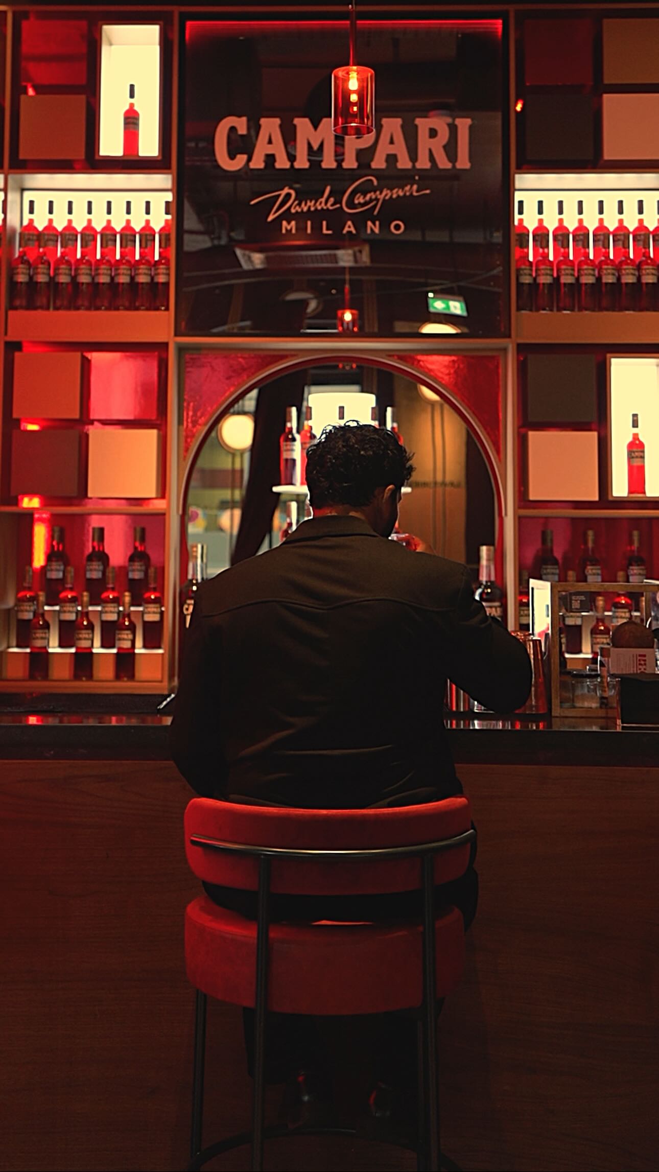 Instagram post by @travelladdoo_eats for Campari. Caption reads: #AD The Alchemist’s Negroni Bar is a year round....