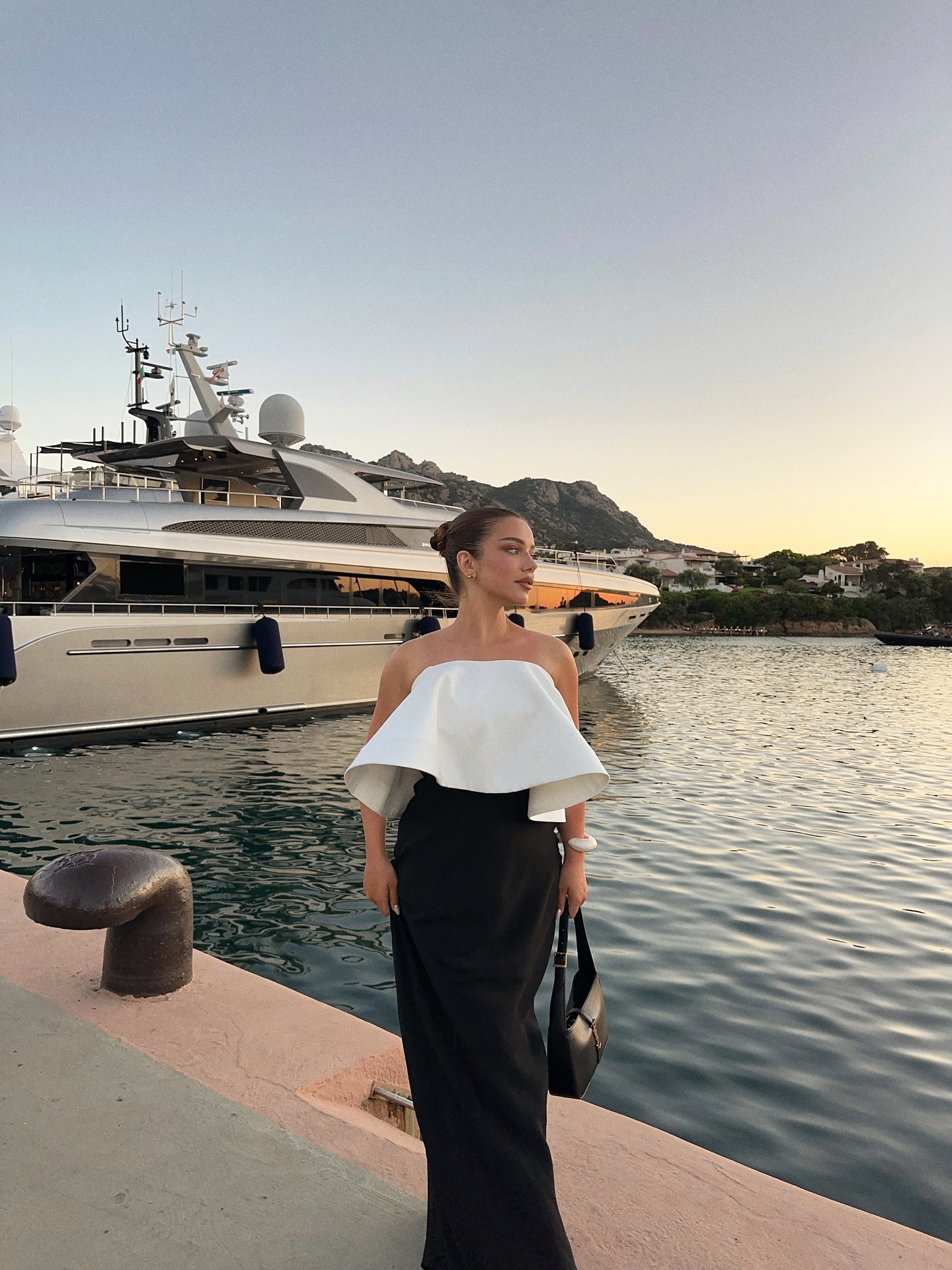 Instagram post by @michaelaberdaga for REVOLVE. Caption reads: Sunset in Porto Cervo🇮🇹
Wearing @loversfriendsla....
