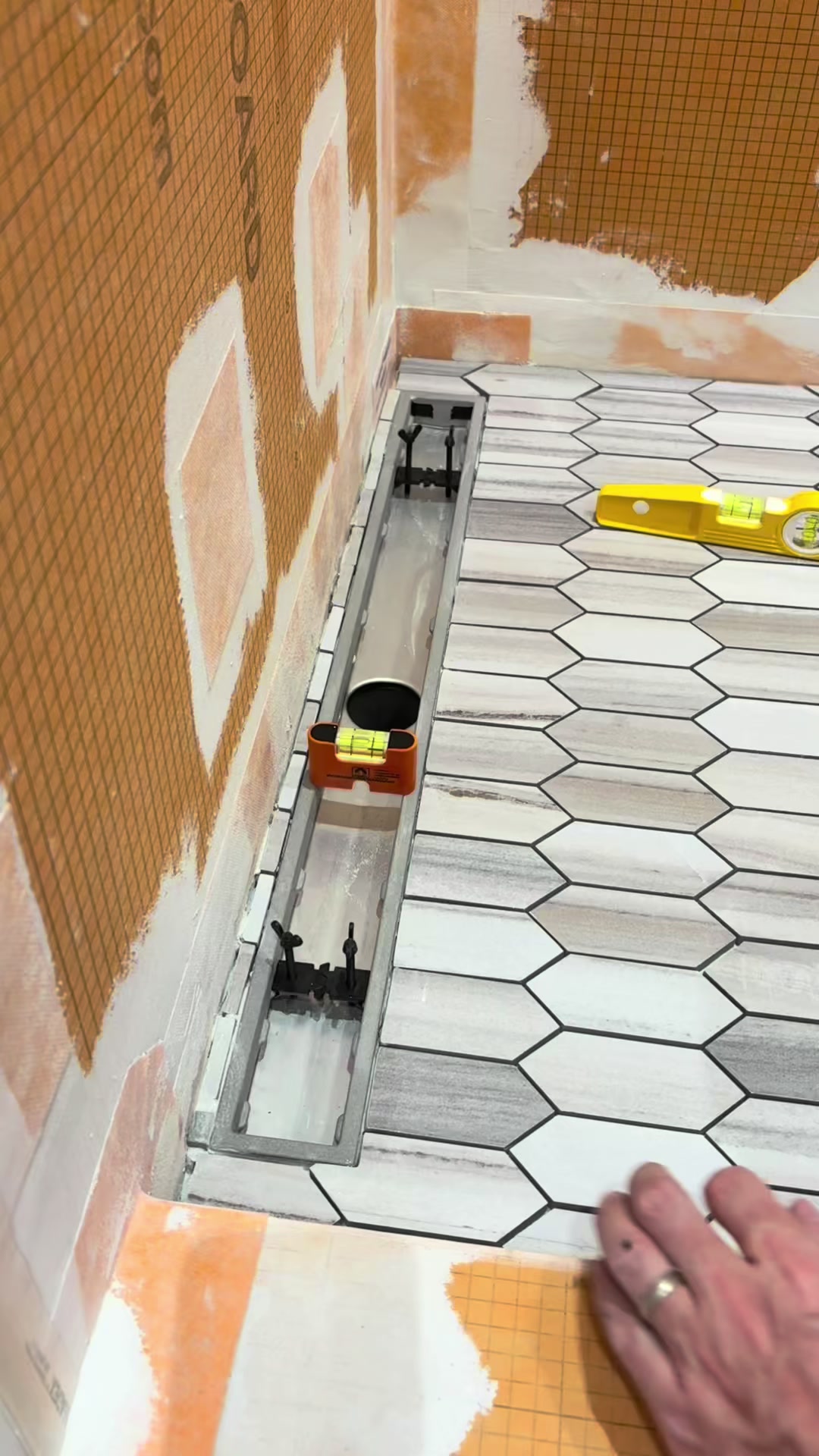TikTok post by @dj.tiling for STABILA. Caption reads: @schlutersystemsna shower base tile install going....