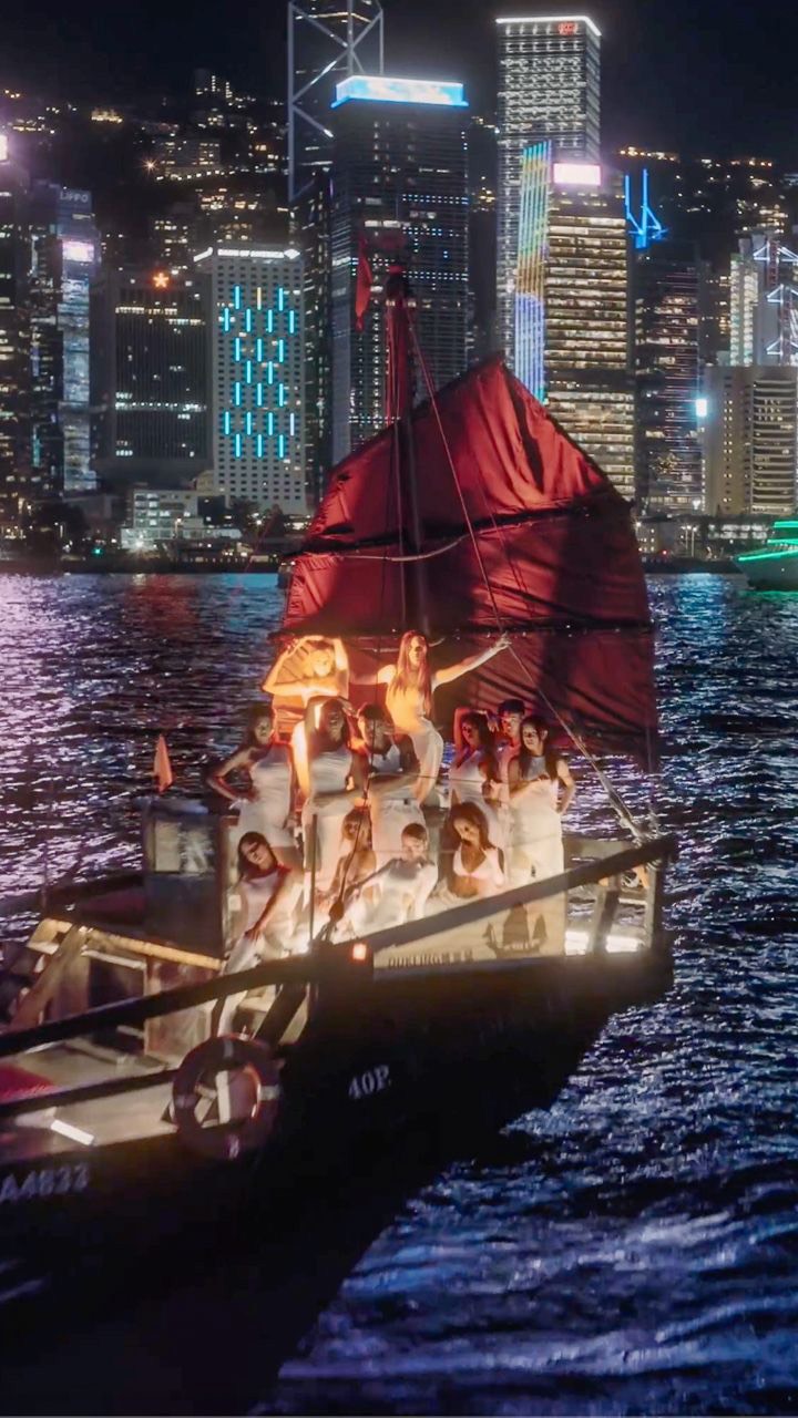 Instagram post by @nowunited for Discover Hong Kong. Caption reads: BEAUTIFUL WORLD IS OUT NOW! 🎉🥳 A heartfelt thank....