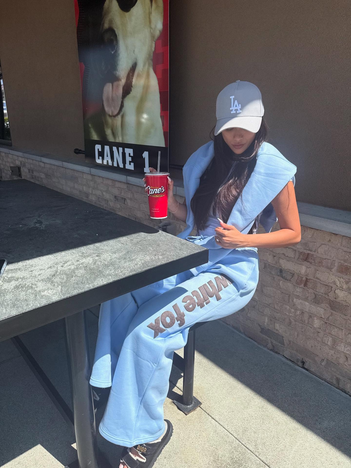 Instagram post by @kat_clark_ for White Fox Boutique. Caption reads: 🇺🇸 Lounge wear and fast food all day everyday 🫣....