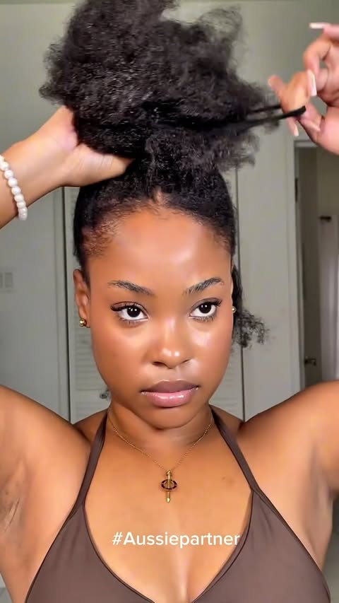 Instagram post by @akhalia.fearon for Aussie Hair. Caption reads: 25 years natural taught me the truth:
Holiday hair....