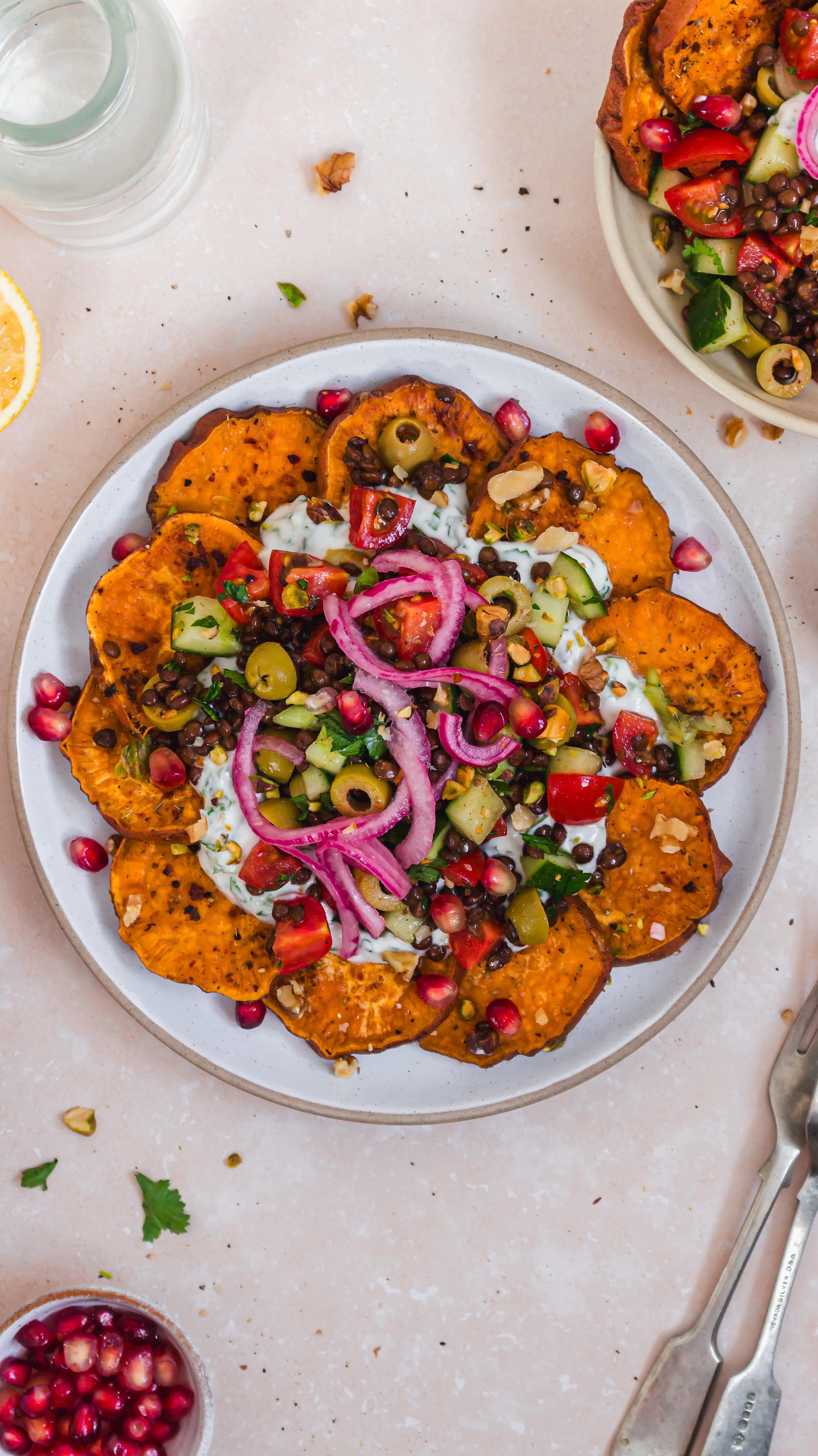Instagram post by @nourishing.amy for The Kitchn. Caption reads: Mediterranean Style Loaded Sweet Potato Nachos....