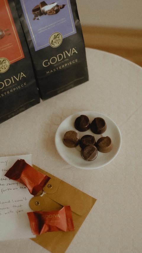 Instagram post by @xxjmitch for Godiva. Caption reads: Words inked with memory, @godiva Masterpiece....