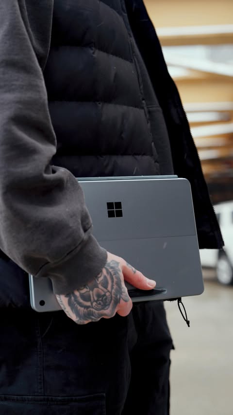 Instagram post by @johnnyhochstetler for Microsoft Surface. Caption reads: #SurfacePartner Staying productive on the go just....