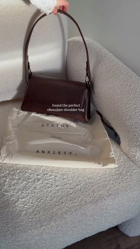 Instagram post by @xeniatraill for Status Anxiety. Caption reads: [...] Cocoa Dual Strap Shoulder Bag //....