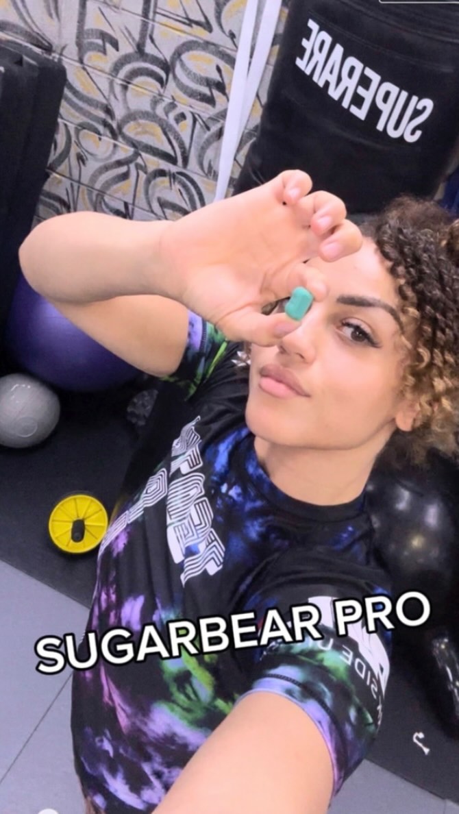 Instagram post by @taelornmoore for SugarbearPRO. Caption reads: Ad 🥋 @SugarbearPro Hair Vitamins to maintain my....