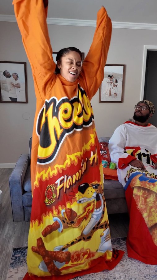 Instagram post by @kenneth.and.dedria for Snuggie. Caption reads: [...] Super Bowl on the couch in our....