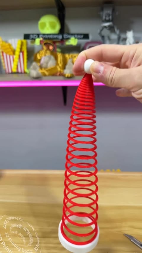 Instagram post by @3dprintingdoctor for Bambu Lab. Caption reads: Making Santa’s hat but make it slinky and slow mo....