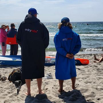 Instagram post by @oleschwarz for Starboard. Caption reads: 😶‍🌫️ Warm #dryrobe #sup #dm #germanchampionship....