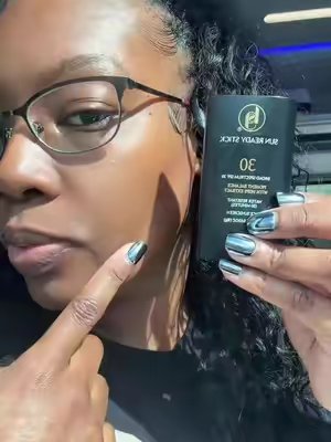 TikTok post by @thomasadrianna for Black Girl Sunscreen. Caption reads: Black girl sunscreen stick comes in handy as a....