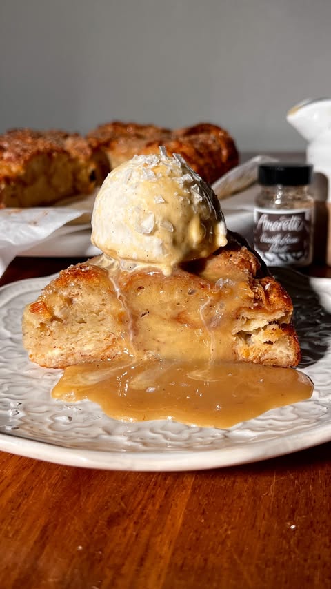 Instagram post by @wellmadebykiley for Amoretti. Caption reads: say it with me: bread pudding is the coziest....
