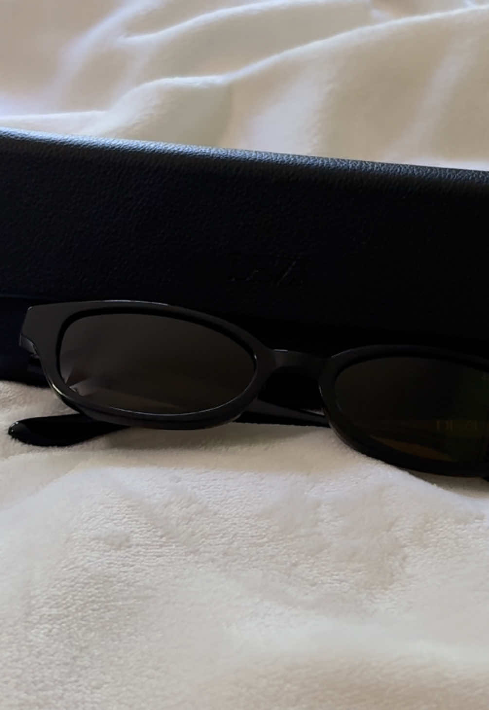 TikTok post by @e.corinne.beauty for DEZI. Caption reads: I love me some tiny sunglasses @DEZI EYEWEAR [...].