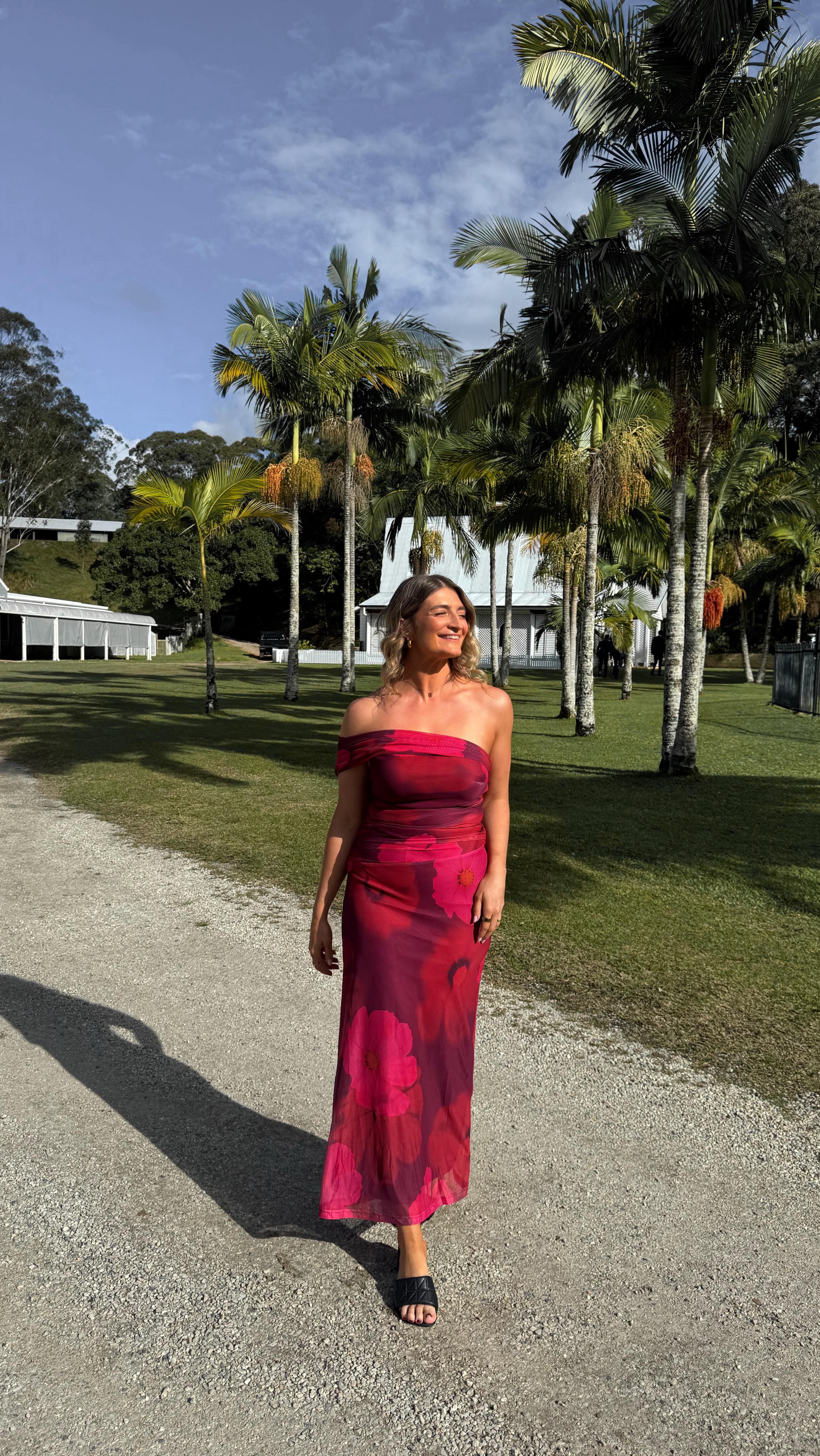 Instagram post by @livewithelle for Gingham and Heels. Caption reads: The perfect wedding guest dress from....