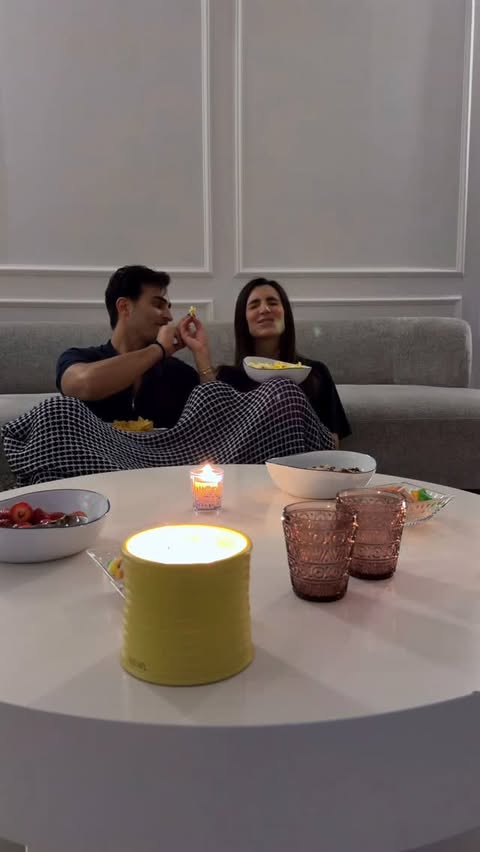 Instagram post by @aliandwalaa for talabat. Caption reads: [...] fighting over which movie to watch😇🍿....