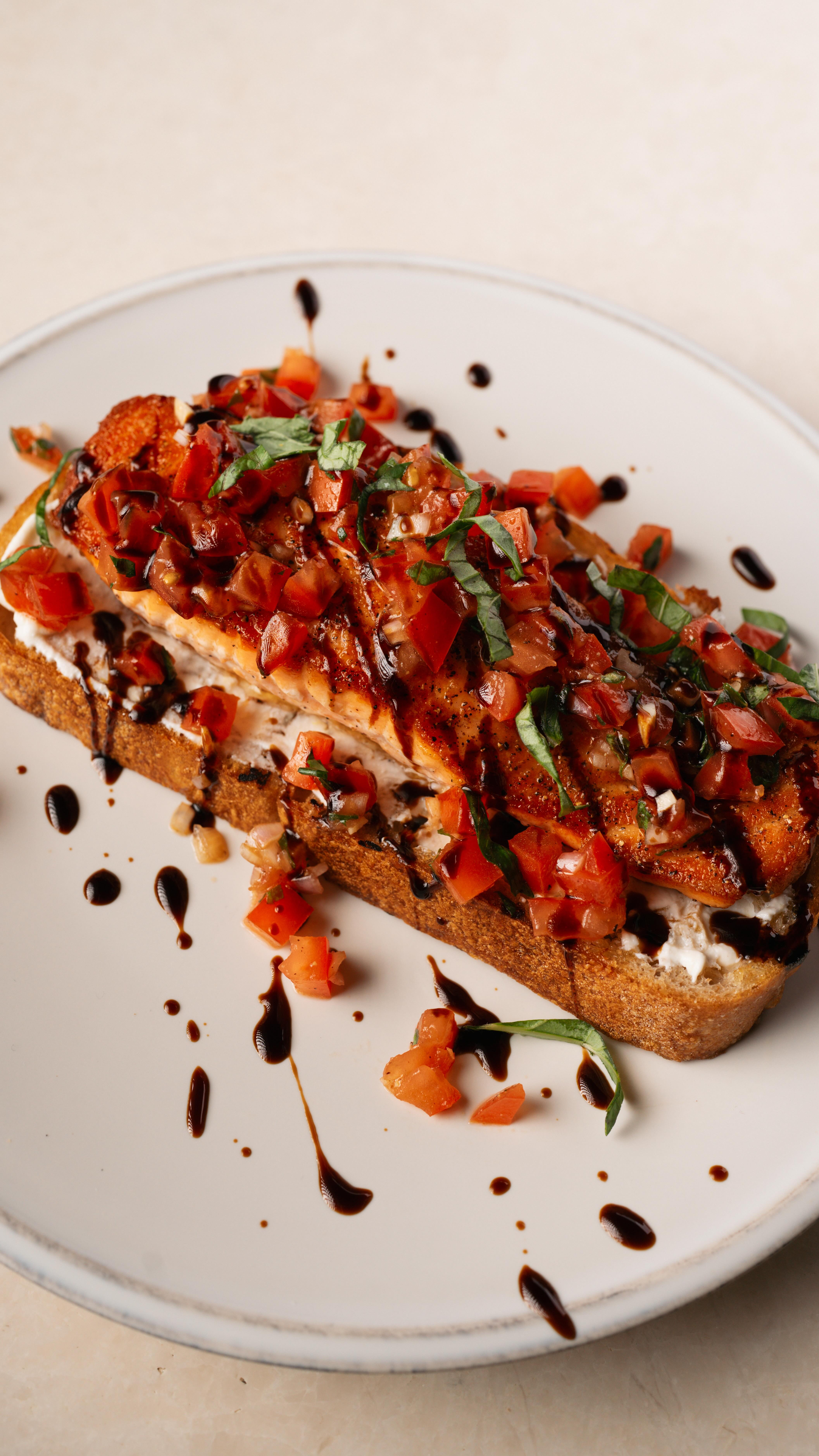 Instagram post by @mypaleoishlife for Bertolli. Caption reads: Salmon Bruschetta Toast
 Crispy sourdough. Lemon....